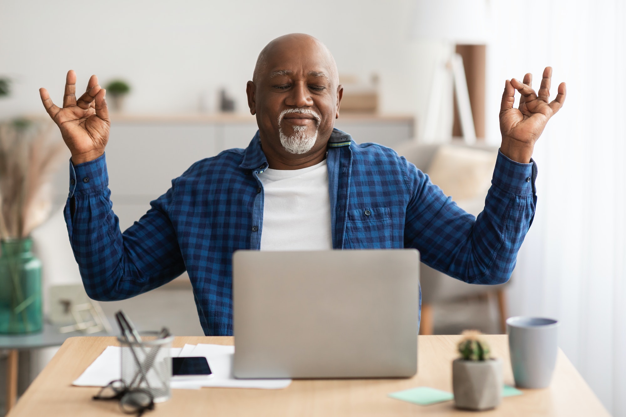 Peaceful Senior Black Man Meditating Sitting At Laptop At Workplace